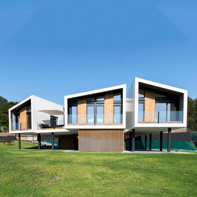 plano general de la casa modular terminada y acabada cielo azul día soleado, césped verde